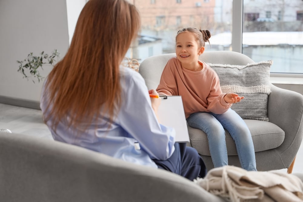 Child Expert Network consultant speaking with young girl during family report assessment session